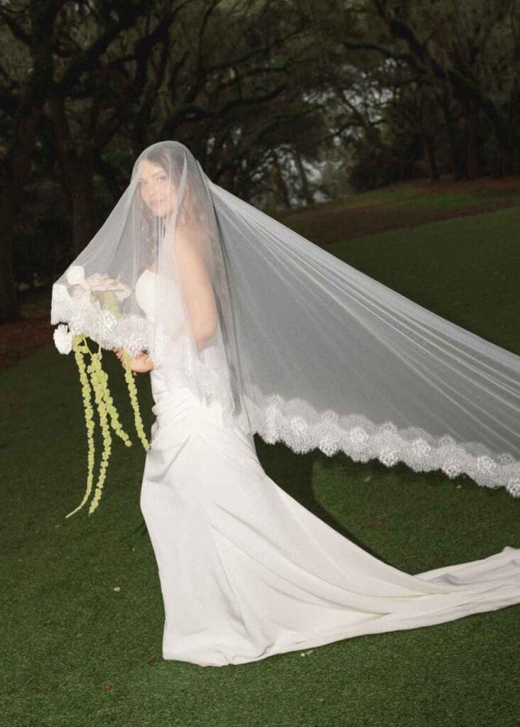 bridal portrait of a bride under the avenue of oaks at the legare waring house