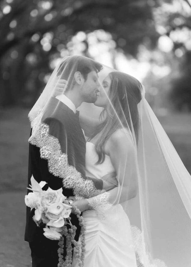 bride and groom just married in charleston, sc, under the veil