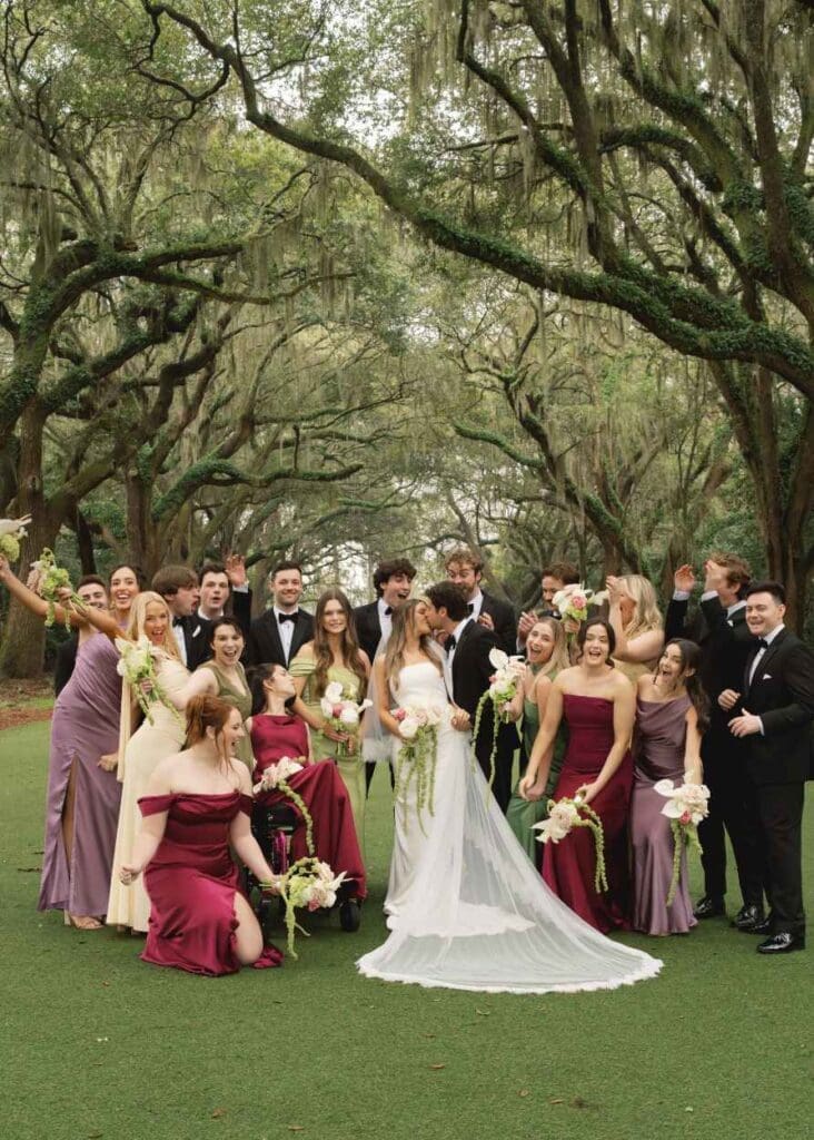 bridal party under the oak trees at the legare waring house, colorful bridal party celebrating