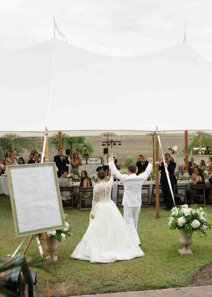 bride and groom entering reception tent in beaufort sc